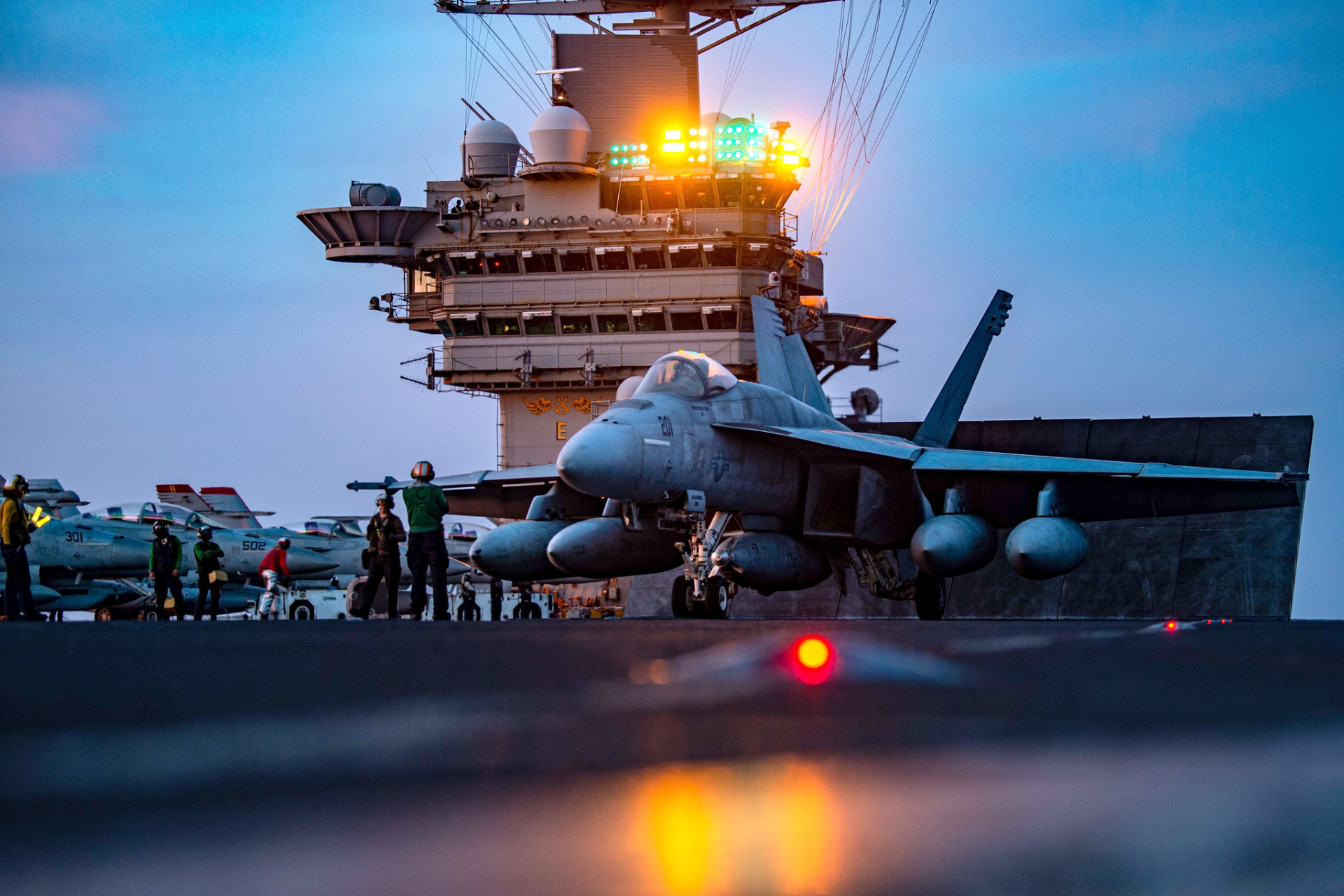 A fighter jet laying aboard a navy battleship